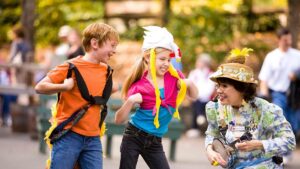 Close up of two kids playing at Dollywood with Miss Lillian on a sunny day in Pigeon Forge, Tennessee, USA